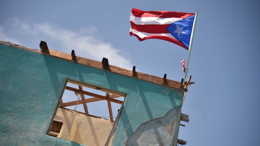 A flag of Puerto Rico is seen on a damaged house in Yabucoa, in the east of Puerto Rico, on September 28, 2017.
The US island territory, working without electricity, is struggling to dig out and clean up from its disastrous brush with hurricane Maria, blamed for at least 33 deaths across the Caribbean. / AFP PHOTO / HECTOR RETAMAL        (Photo credit should read HECTOR RETAMAL/AFP/Getty Images)