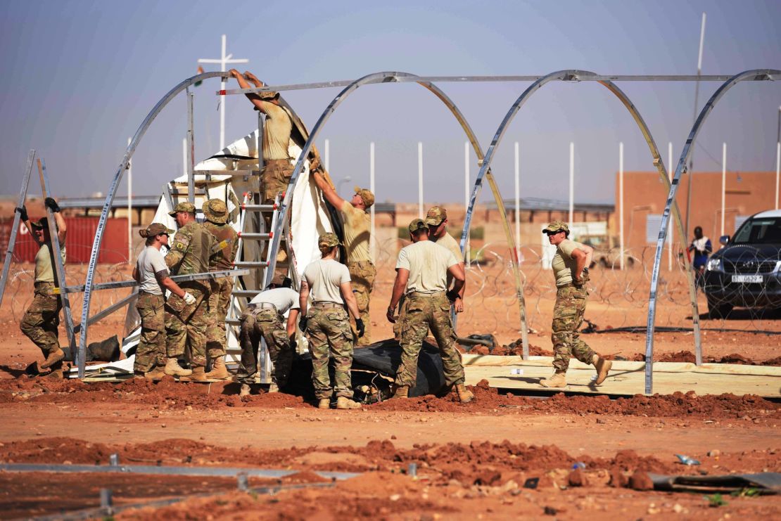 US airmen frtake down tents from the old base to move to a new location, on September 11, 2017, at Air Base 201 in Agadez, Niger. 