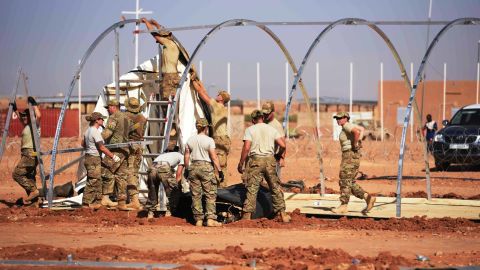 US airmen frtake down tents from the old base to move to a new location, on September 11, 2017, at Air Base 201 in Agadez, Niger. 