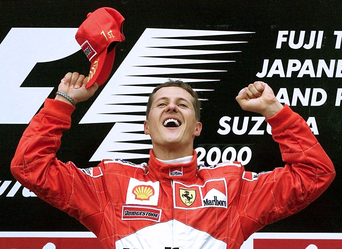 Michael Schumacher celebrates on the podium after winning the 2000 Japanese GP