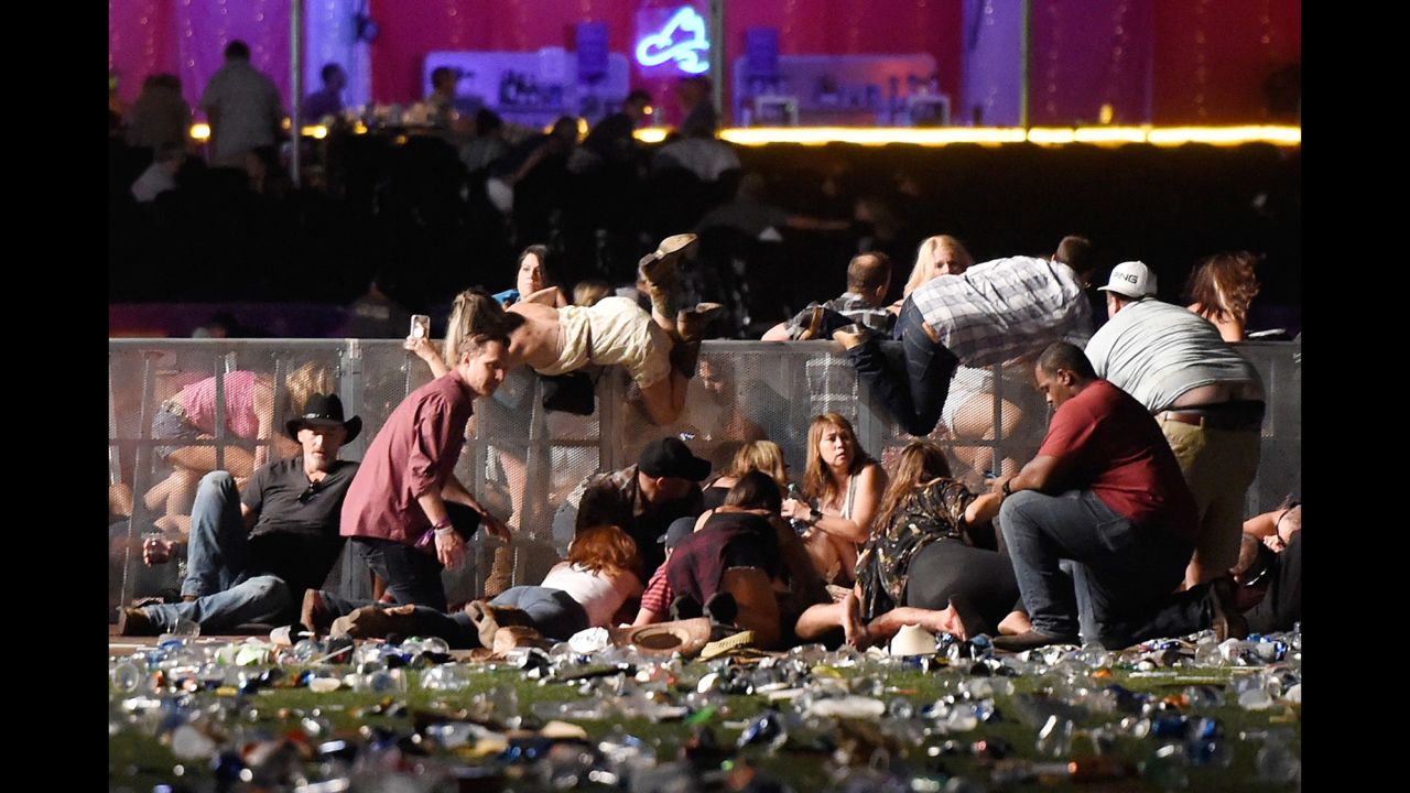 People scramble for shelter at the Route 91 Harvest country music festival. The shooter's motive remains a mystery.