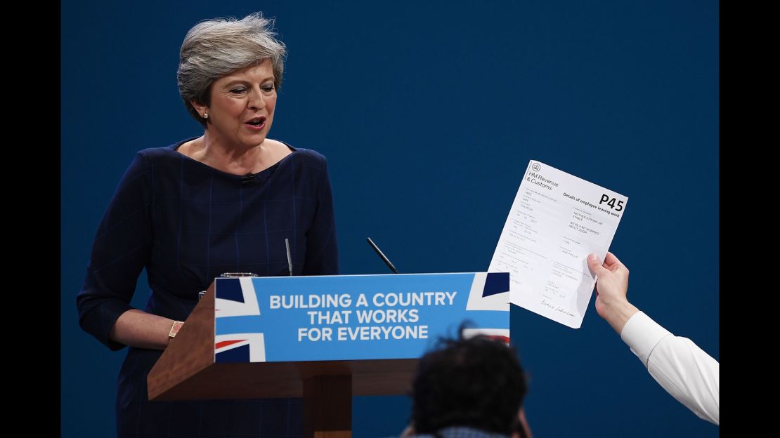 A comedian hands Theresa May a P45 during her keynote conference speech in October 2017.