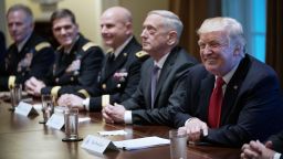 US President Donald Trump smiles as Defense Secretary James Mattis (2L) looks on during a meeting with senior military leaders in the Cabinet Room of the White House on October 5, 2017. 