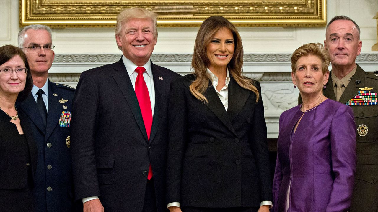 WASHINGTON, DC - OCTOBER 5:  U.S. President Donald Trump and first lady Melania Trump pose for pictures with senior military leaders and spouses, including including Gen. Joseph Dunford (R), chairman of the joint chiefs of staff, and General Paul Selva (2nd L), vice chairman of the joint chiefs of staff, after a briefing in the State Dining Room of the White House October 5, 2017 in Washington, D.C.