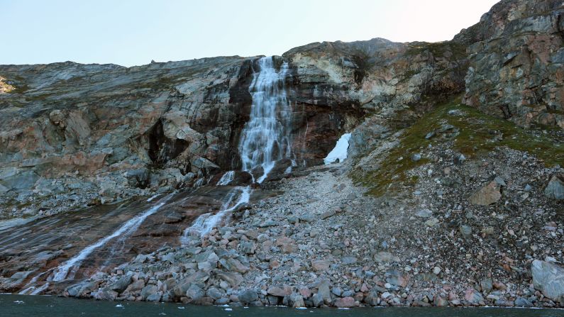 A couple of hours into the journey, a giant waterfall cascades from the cliffs -- a fantastic photo opportunity! 