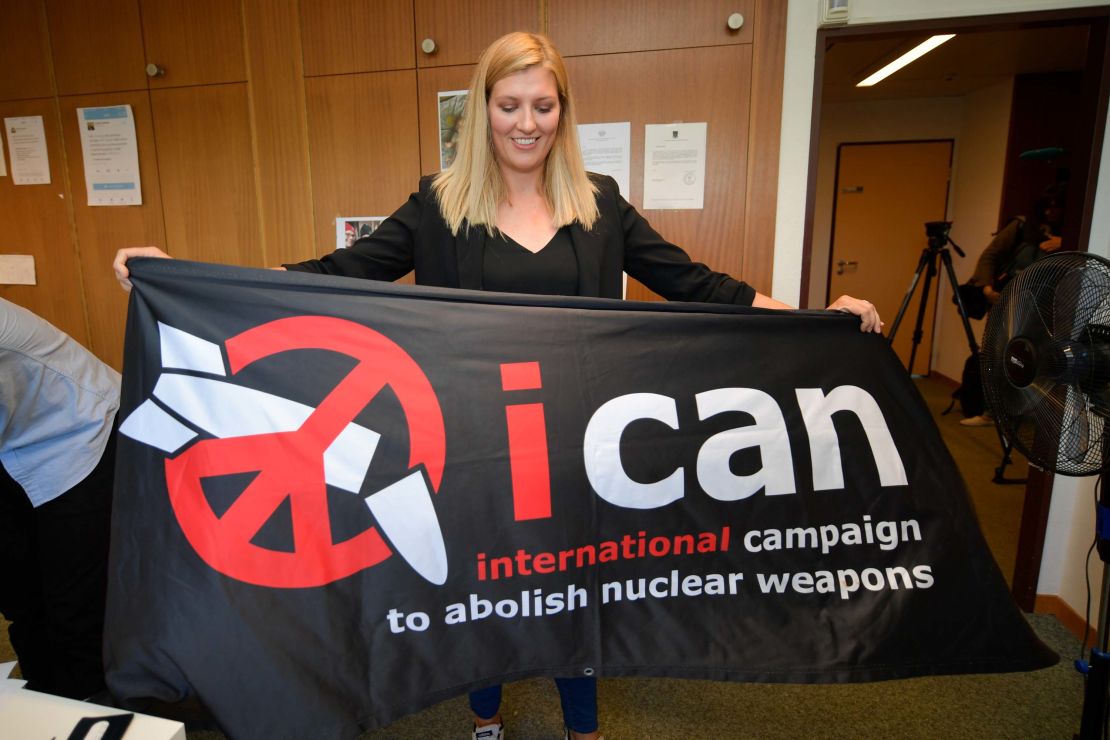 Nuclear disarmament group ICAN executive director Beatrice Fihn holds a banner with their logo after ICAN won the Nobel Peace Prize.