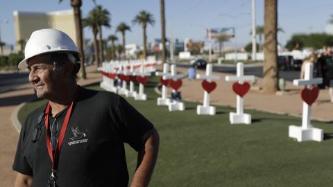 Greg Zanis stands in front of crosses he placed near the city's famous sign Thursday, Oct. 5, 2017, in Las Vegas. The crosses are in honor of those killed when Stephen Craig Paddock broke windows on the Mandalay Bay resort and casino and began firing with a cache of weapons onto a country music festival Sunday. Dozens of people were killed and hundreds were injured. (AP Photo/Gregory Bull)
