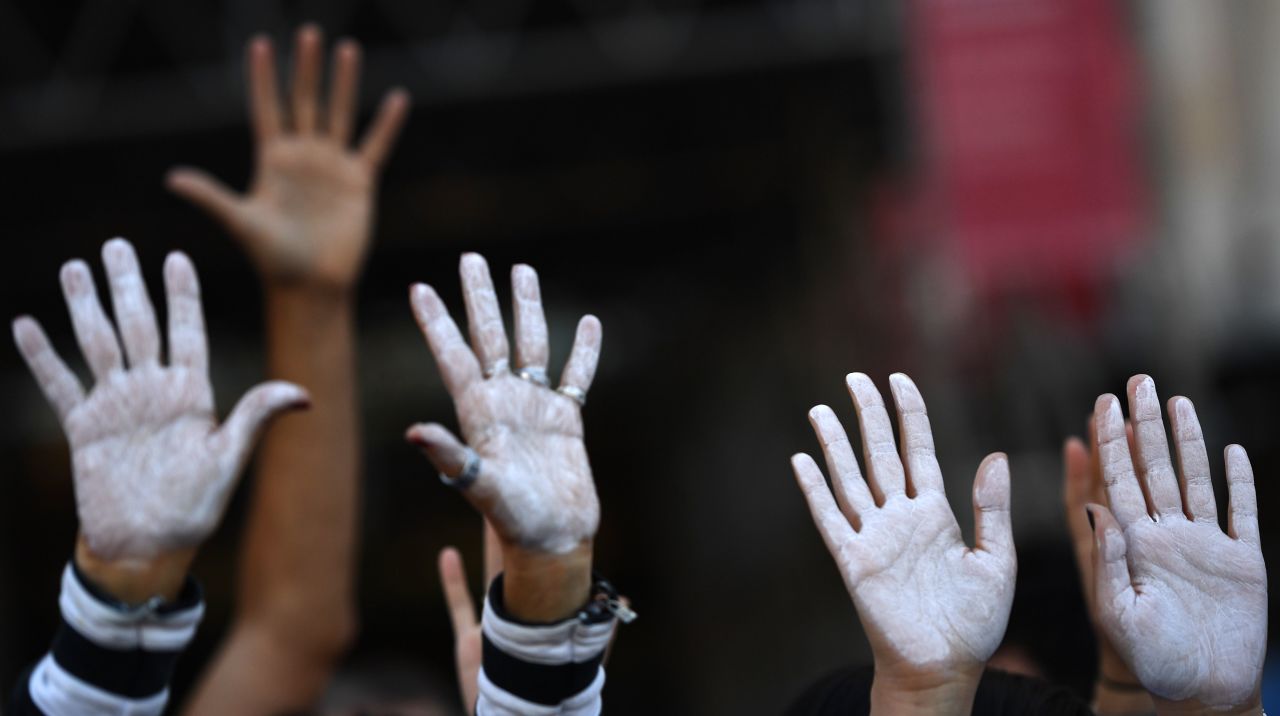 People show their hands painted in white during a demonstration urging dialogue on October 7 in Madrid.  Neither the Catalan regional government nor the national government in Madrid has been willing to give ground since the referendum. 