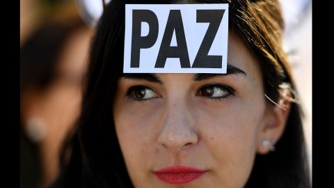 A woman wears a sticker with the Spanish word for "peace" at a demonstration in Madrid on October 7.