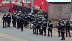 Cameroon police officials walk with riot shields on a street in the administrative quarter of Buea on October 1, 2017.
