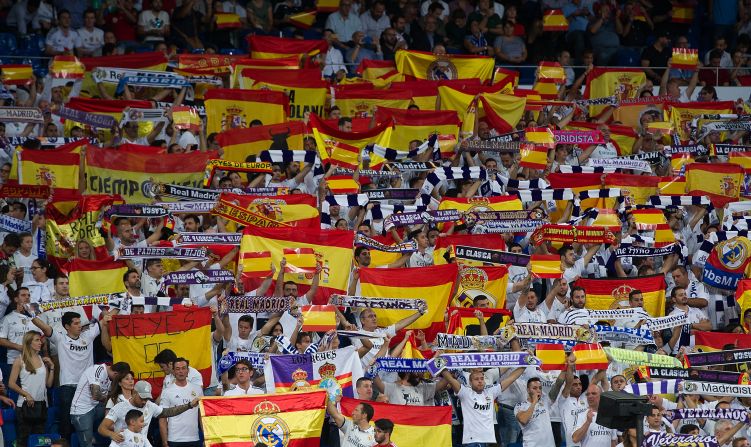 Real Madrid fans wave Spanish flags during the La Liga match between Real Madrid and Espanyol to show their opposition to the Catalonia independence referendum on the same day. 