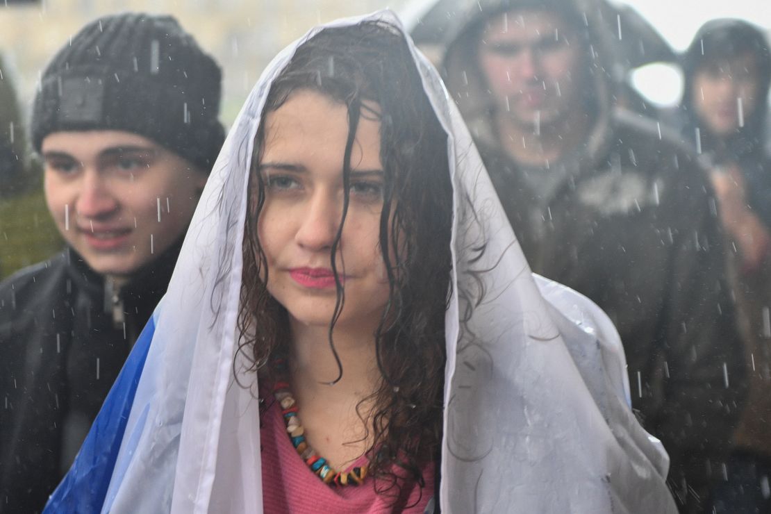 A woman protesting in the rain Saturday in support of jailed activist Alexei Navalny.