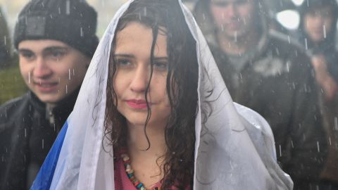 A woman protesting in the rain Saturday in support of jailed activist Alexei Navalny.
