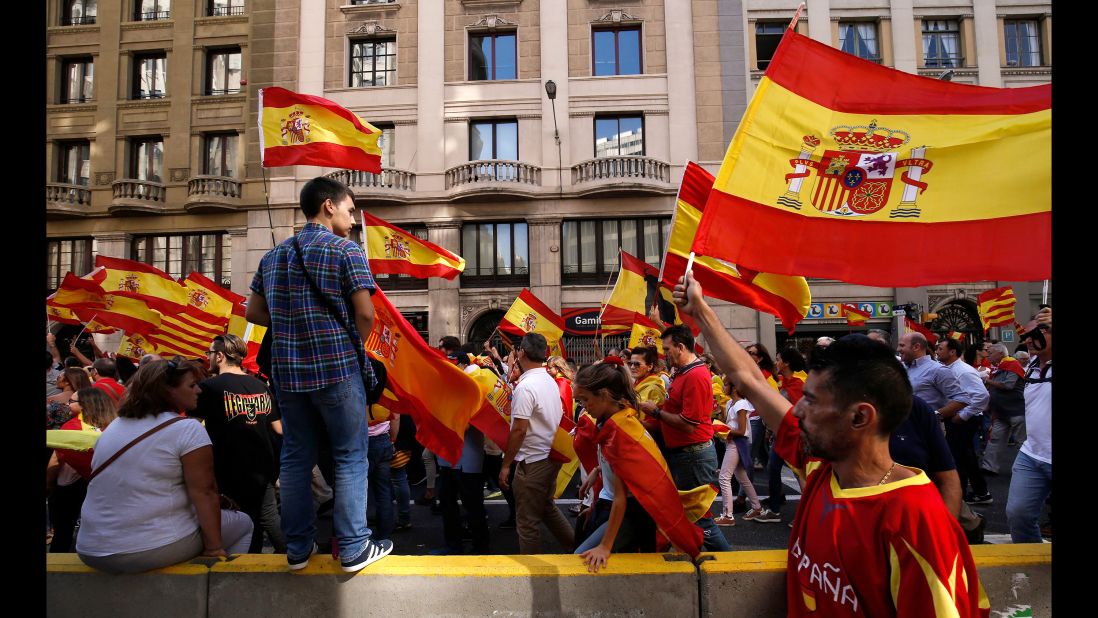 Protesters hold Spanish flags during a demonstration against independence for Catalonia on October 8.