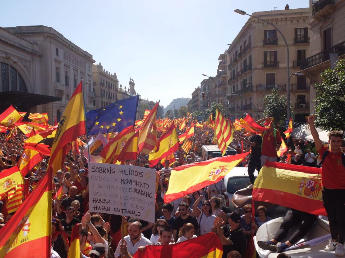 Protesters wave Spanish, Catalan and European Union flags in a call for unity on October 8, 2017, in Barcelona, Spain. 