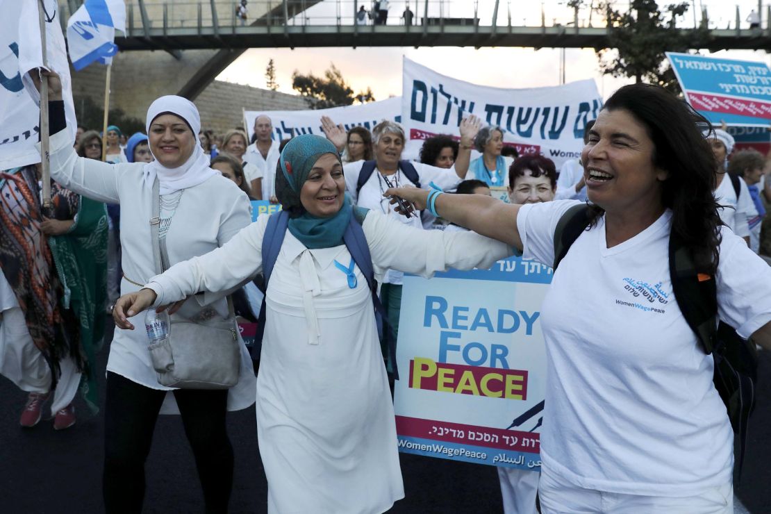 Palestinian and Israeli activists march in the heart of Jerusalem demanding a Mideast peace deal.