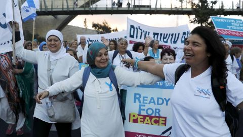 Palestinian and Israeli activists march in the heart of Jerusalem demanding a Mideast peace deal.