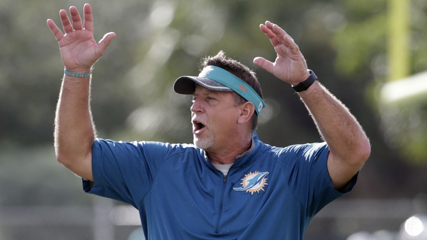 FILE - In this Aug. 16, 2016, file photo, Miami Dolphins offensive line coach Chris Foerster watches as players do drills during practice at NFL football training camp in Davie, Fla. The NFL and the Miami Dolphins say they're aware of a social media video allegedly showing offensive line coach Chris Foerster snorting a white powdery substance. NFL spokesman Brian McCarthy said Monday, Oct. 9, 2017, the league will review the 56-second video, which was posted on Facebook and Twitter. (AP Photo/Lynne Sladky, File)