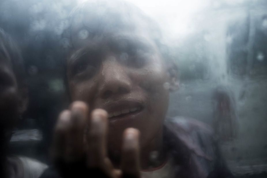 A young Rohingya refugee begs for food through the glass of a car window at Balukhali refugee camp in Bangladesh on October 7.