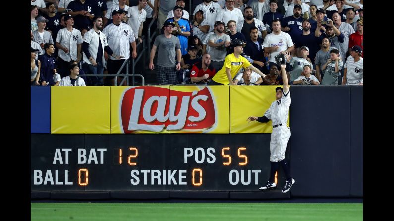 The New York Yankees' Aaron Judge leaps and catches a deep fly ball during the sixth inning against the Cleveland Indians in Game 3 of the American League Division Series at Yankee Stadium on Sunday, October 8, in New York. The 6'7" Judge caught the potential home run against the Indians, helping the Yankees preserve the lead as the team won 0-1. Yankees still trail the series 1-2.