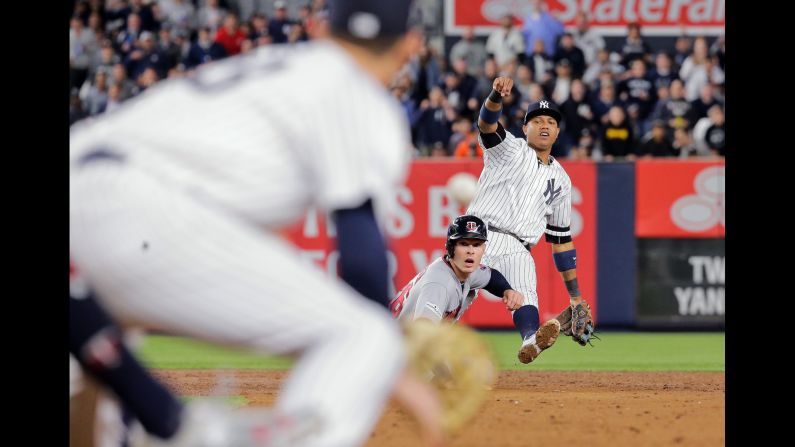 New York Yankees second baseman Starlin Castro, right, tries to throw to first baseman Greg Bird, left, for the double-play after forcing out Minnesota Twins right fielder Max Kepler. The Yankees defeated the Twins 8-4 during the 2017 MLB Playoffs American League Wild Card Game on Tuesday, October 3.