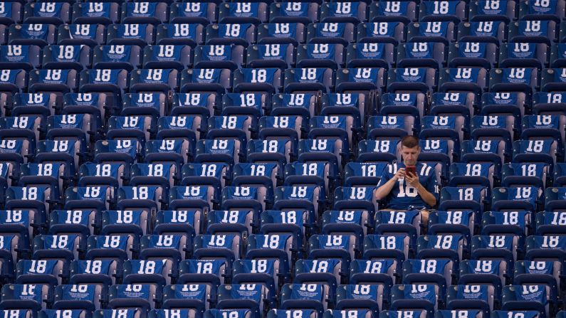 An Indianapolis Colts fan sits in the stands surrounded by towels honoring Peyton Manning before the NFL game between the San Francisco 49ers and Indianapolis Colts on Sunday, October 8, in Indianapolis. The Colts unveiled a <a href="index.php?page=&url=http%3A%2F%2Fbleacherreport.com%2Farticles%2F2737436-peyton-manning-statue-unveiled-outside-of-colts-lucas-oil-stadium" target="_blank" target="_blank">statue in Manning's honor</a> at the game and retired his number.