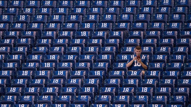 An Indianapolis Colts fan sits in the stands surrounded by towels honoring Peyton Manning before the NFL game between the San Francisco 49ers and Indianapolis Colts on Sunday, October 8, in Indianapolis. The Colts unveiled a <a target="_blank" target="_blank">statue in Manning's honor</a> at the game and retired his number.