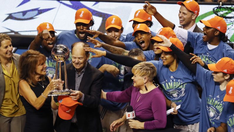 Minnesota Lynx team owner Glen Taylor accepts the WNBA championship trophy as Lynx players celebrate their WNBA finals win, on Wednesday, October 4, in Minneapolis.