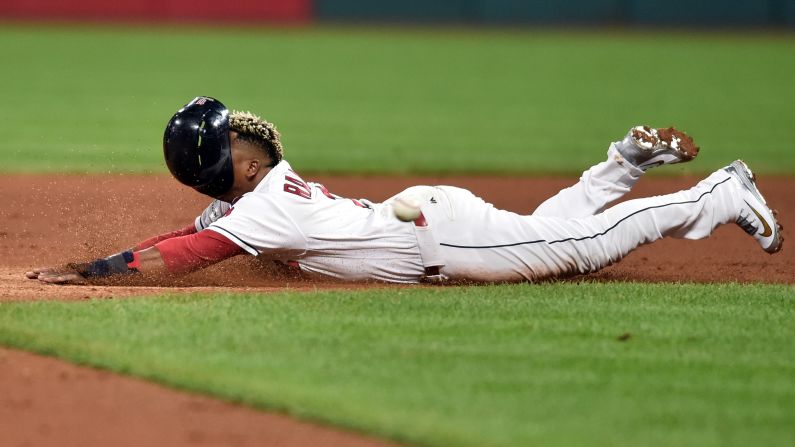 The helmet of Cleveland Indians third baseman Jose Ramirez slides off his head as he steals second base during the fifth inning against the New York Yankees in game one of the 2017 on Thursday, October 5 in Cleveland.