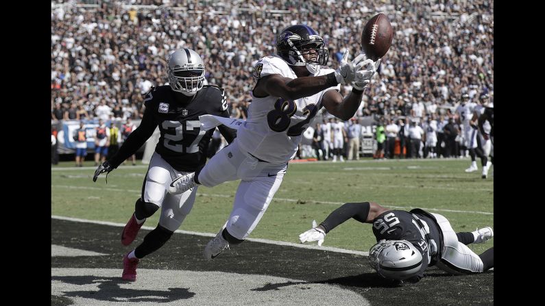Baltimore Ravens tight end Benjamin Watson misses a pass in the end zone in front of Oakland Raiders free safety Reggie Nelson, left, during the first half of an NFL football game in Oakland, on Sunday, October 8.