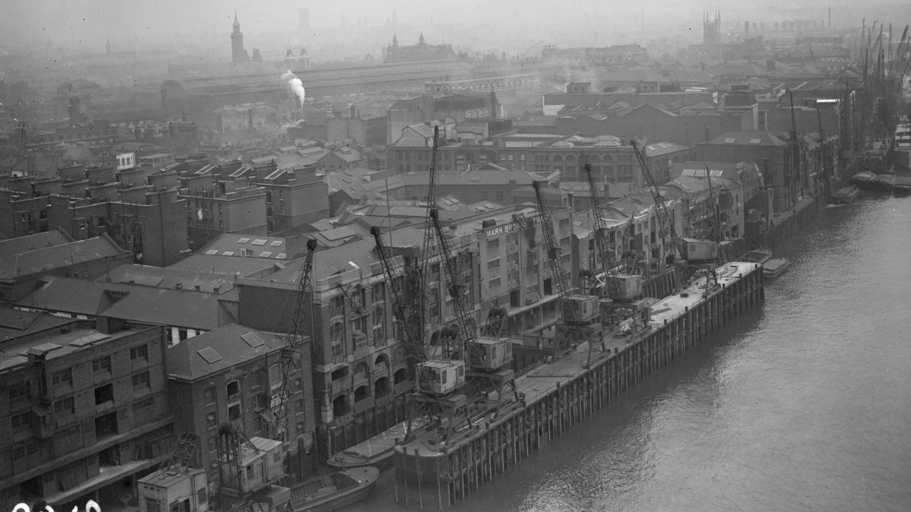 A view of London from Tower Bridge shows warehouses in 1982.