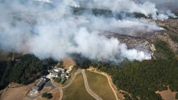 Smoke rises as a wildfire burns near Kenzo Estate in Napa, Calif., Monday, Oct. 9, 2017. Wildfires whipped by powerful winds swept through Northern California sending residents on a headlong flight to safety through smoke and flames as homes burned.