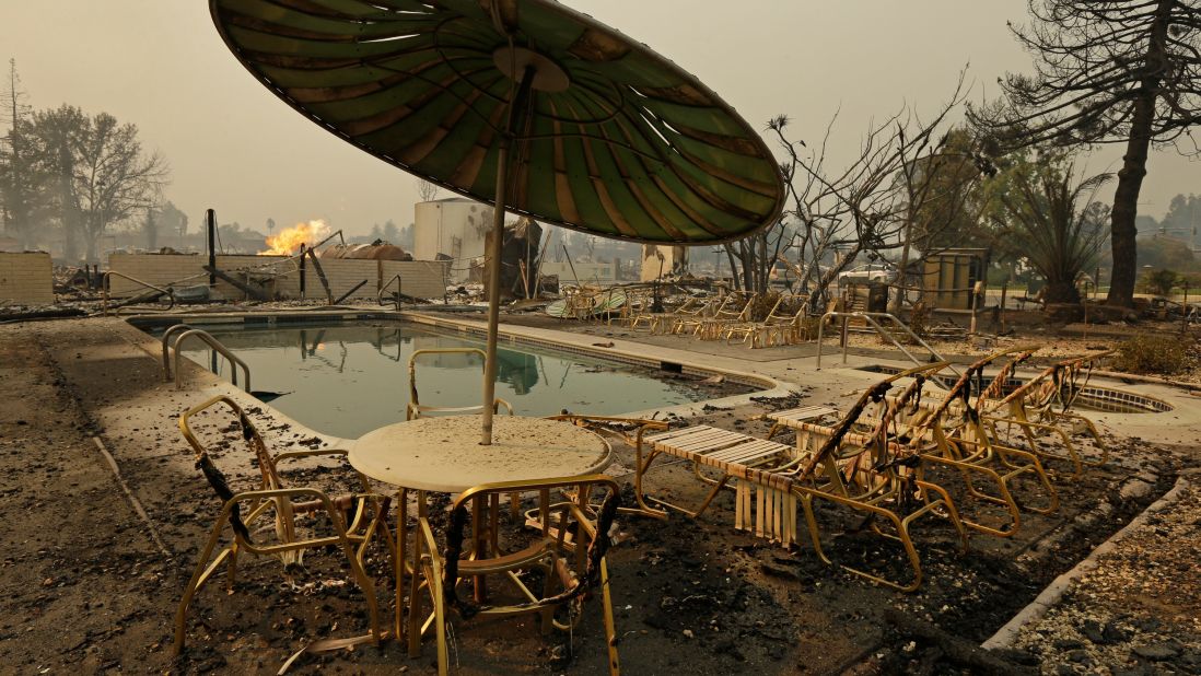 Fire burns from an open gas valve near the pool area of a Santa Rosa trailer park on October 9.