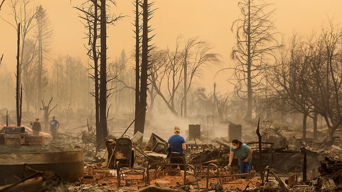 Santa Rosa residents sift through the remains of a burned home on October 9.