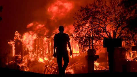 Jim Stites watches as part of his neighborhood burns in Fountaingrove on October 9. 