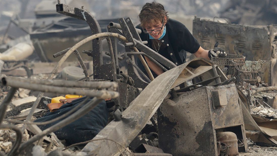 Kristine Pond searches what's left of her family's home in Santa Rosa on October 9.