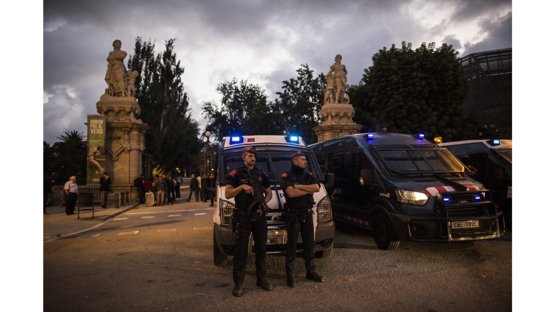 Officers of Catalonia's regional police force stand guard outside the Parliament of Catalonia.