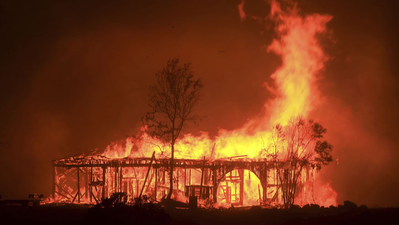 The Historic Round Barn burns, Monday October 9, 2017, in Santa Rosa, Calif. More than a dozen wildfires whipped by powerful winds been burning though California wine country. The flames have destroyed at least 1,500 homes and businesses and sent thousands of people fleeing.