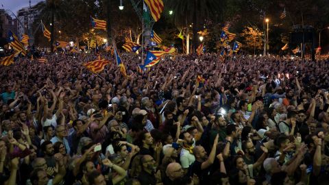 Pro-independence supporters watch Catalan President Carles Puigdemont's speech on a big screen in Barcelona.