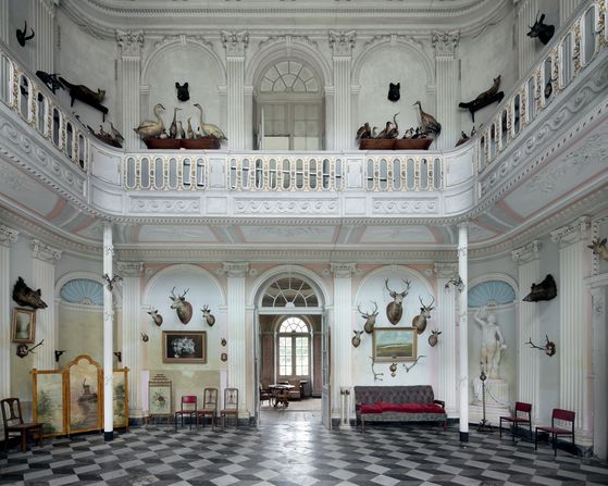 Mozart is said to have spent a night in this lodge in 1763. The last owner couldn't afford basic maintenance, and dust is now accumulating. <br /><br />"The silence inside doesn't really spoil the fun. In the living room, several animal heads mounted on the walls stare at each other while they muse over their glorious past," writes Van Rensbergen.