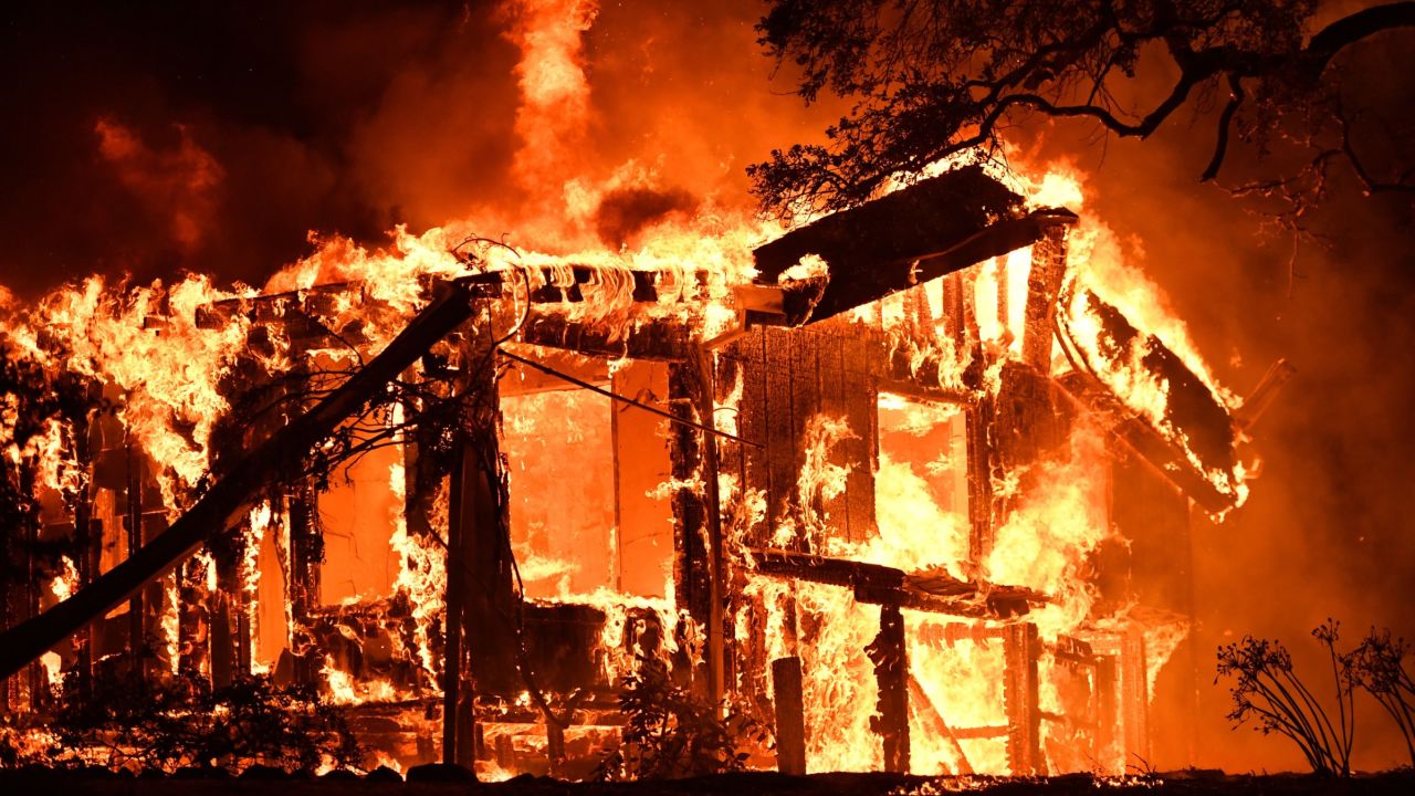 Flames ravage a home in California's Napa wine region as multiple wind-driven fires continue whipping the region. 