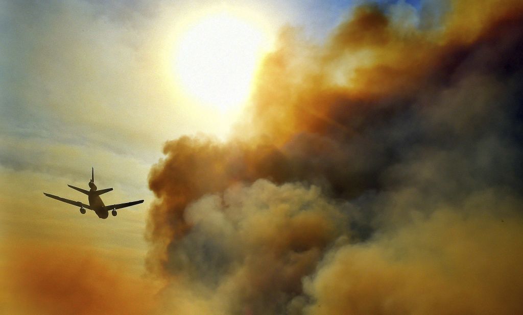 A firefighting plane helps battle a blaze just north of Tustin on October 9.