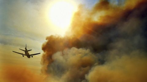 A firefighting plane helps battle a blaze just north of Tustin on October 9.