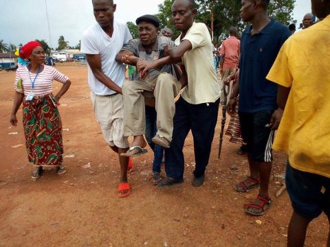 An elderly man is rushed to the Liberian government hospital in Buchanan, after he fainted due to the long, hot wait in a queue outside the Fairground Community polling station in Grand Bassa County.<br />Credit: Local Voices Liberia/Elton Tiah