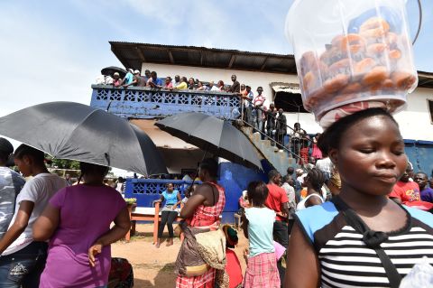 People waiting patiently outside a polling station in Monrovia to cast their votes. <br />Credit: Getty images