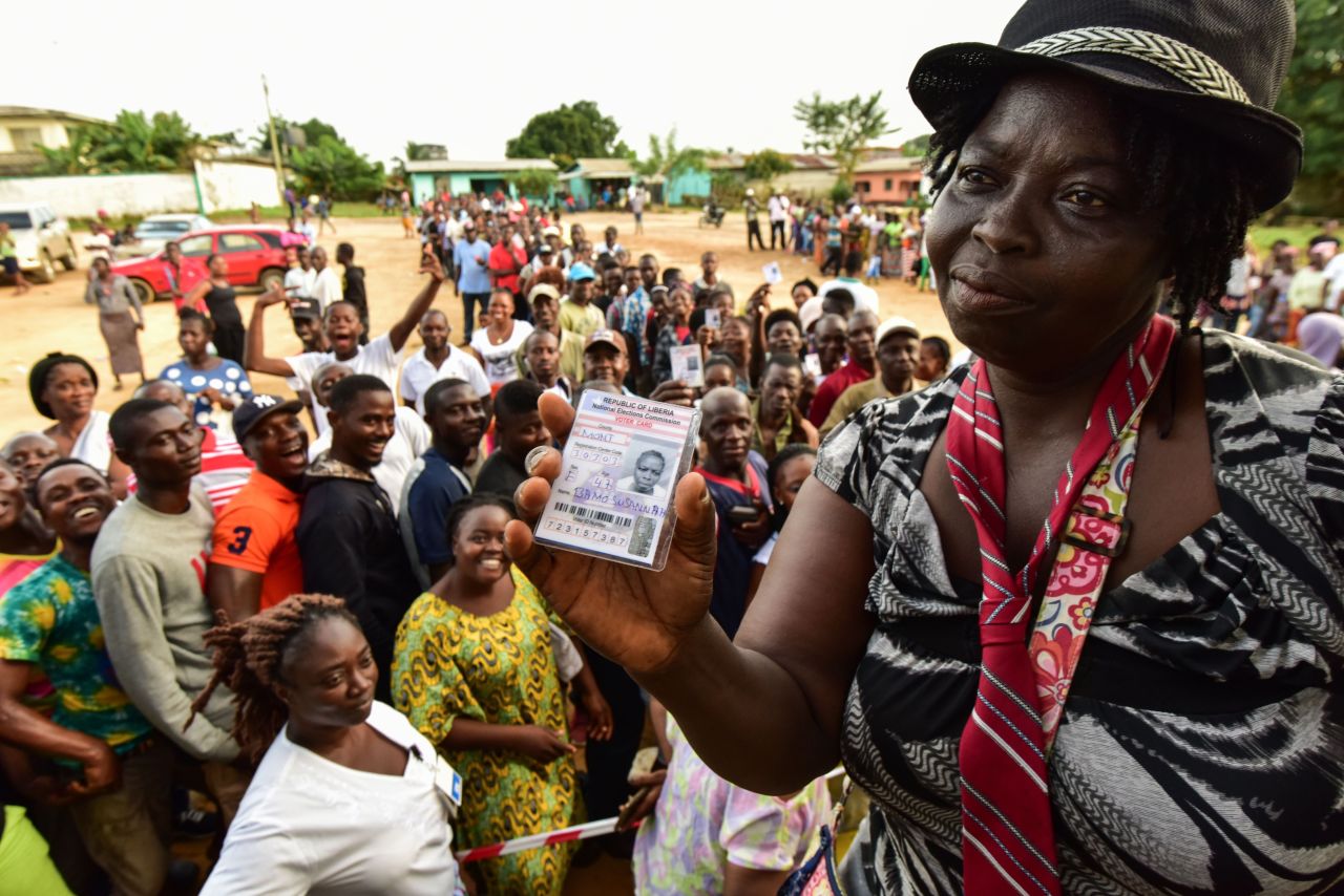 A woman shows her voting card during the elections. <br />Credit: Getty images