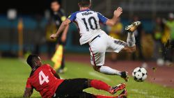 USA's Christian Pulisic (R) is marked by Trinidad and Tobago's Kevon Villaroel during their 2018 World Cup qualifier football match in Couva, Trinidad and Tobago, on October 10, 2017. / AFP PHOTO / Luis ACOSTA        (Photo credit should read LUIS ACOSTA/AFP/Getty Images)