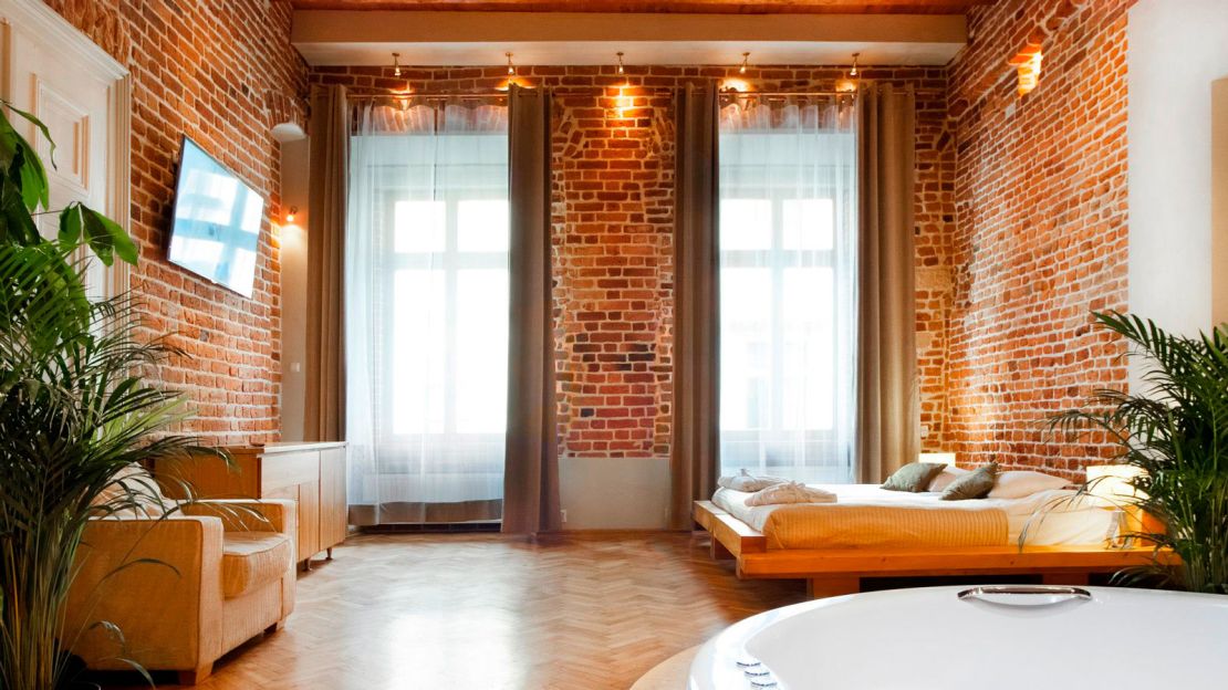 The apartments at Aparthotel Stare Miasto are decked out with brick walls and beamed ceilings.