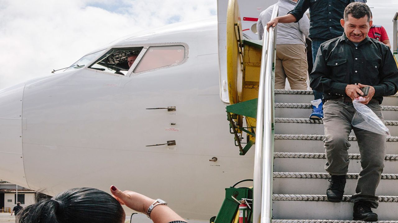 Guatemalan immigration officials meet deportees as they arrive, escorting them to a welcome center.