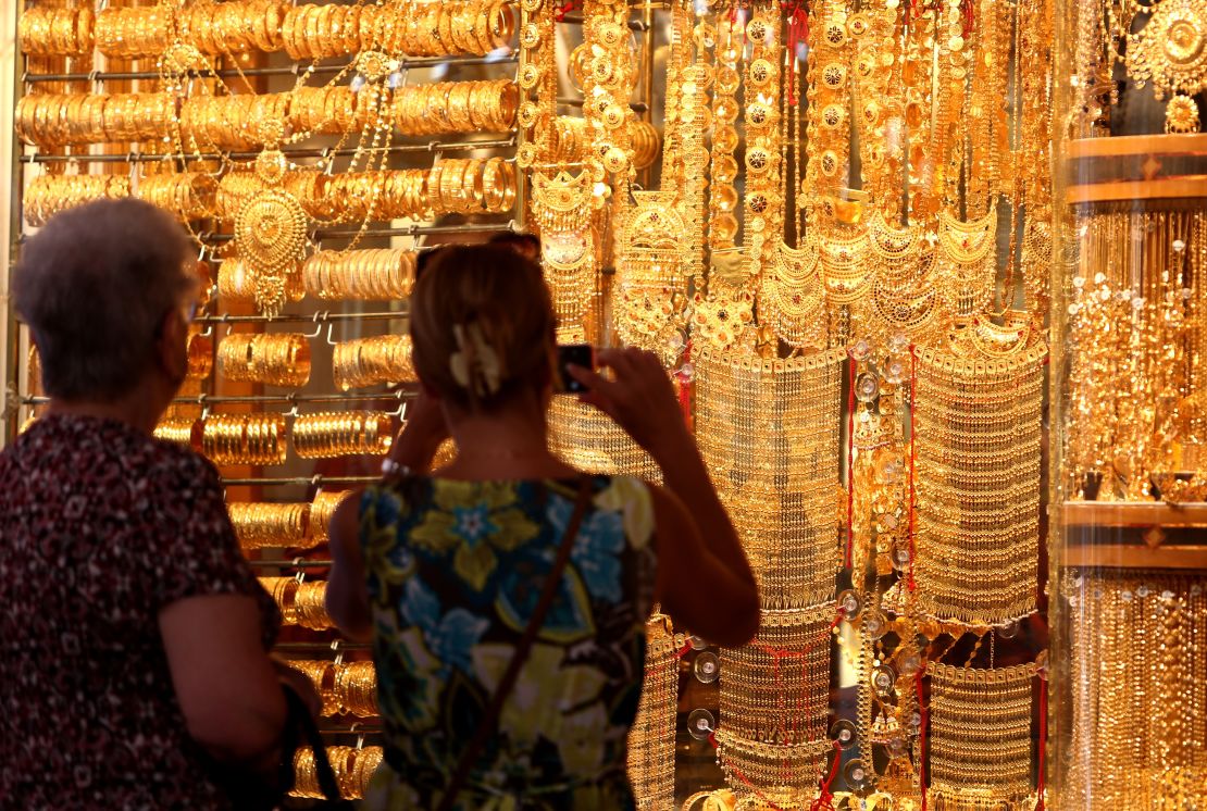 Visitors take pictures at the Dubai Gold Souk 